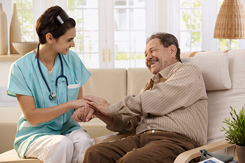 Female nurse caring for a senior male