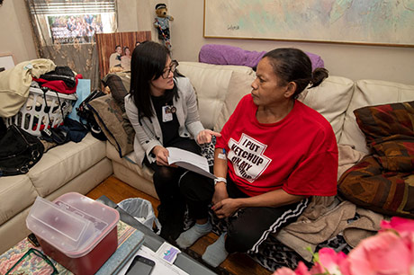 MGH staff caring for a patient in their home